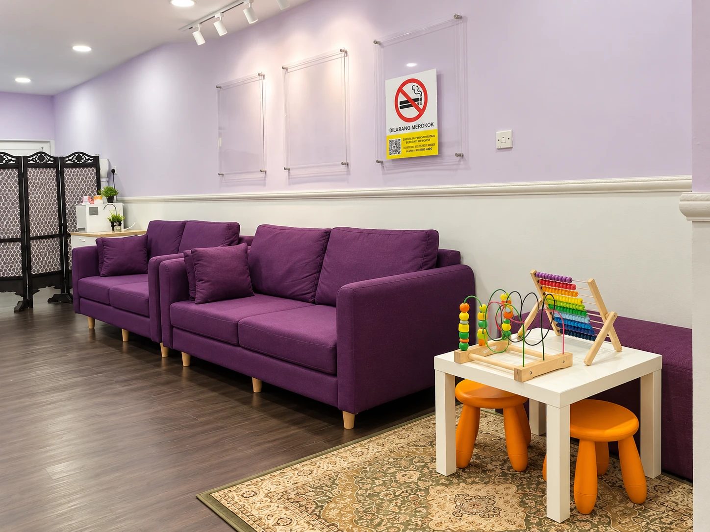 Waiting area with sofas and a children's play table at Dental Suite Bangi