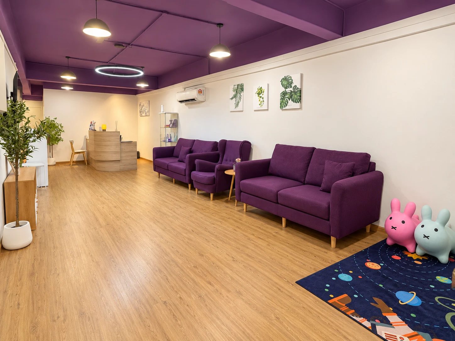 Waiting lounge with seating and a children's play corner at Dental Suite Shah Alam